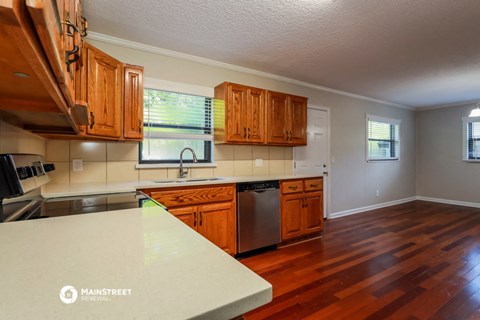 a kitchen with wooden cabinets and a white counter top