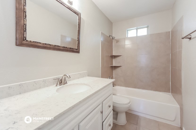 a bathroom with a sink and a toilet and a shower