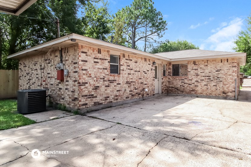 a brick house with a driveway and a garage door