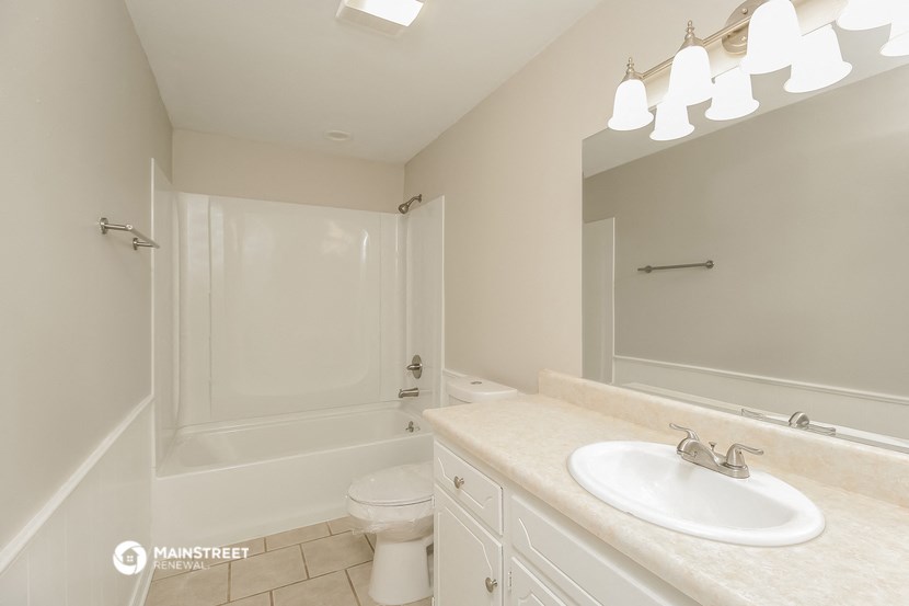 a bathroom with a sink and a toilet and a shower