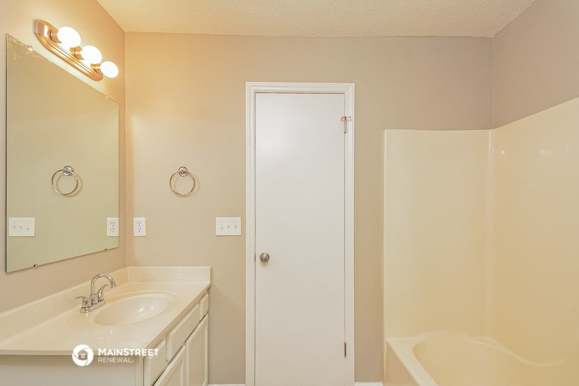 a bathroom with a sink and a mirror and a shower