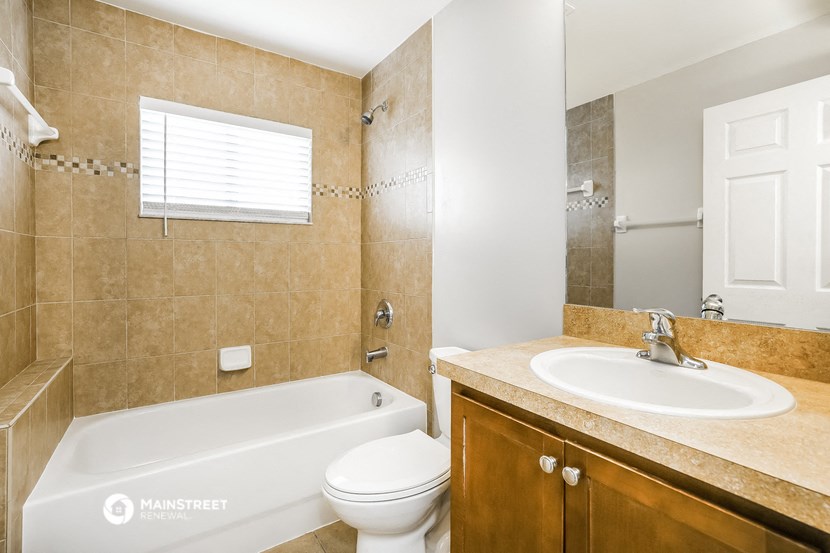 a bathroom with a sink toilet and a tub