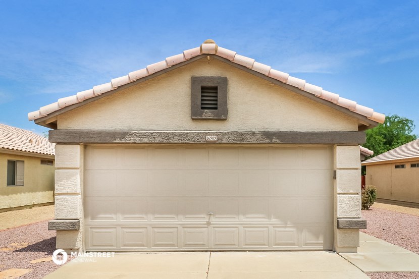 a garage with a white garage door and a roof