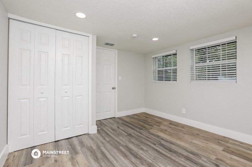 the living room of a new home with white walls and wood flooring