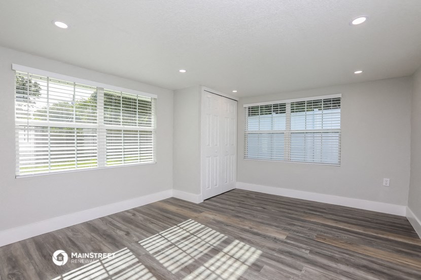 the living room of a manufactured home with wood flooring and windows