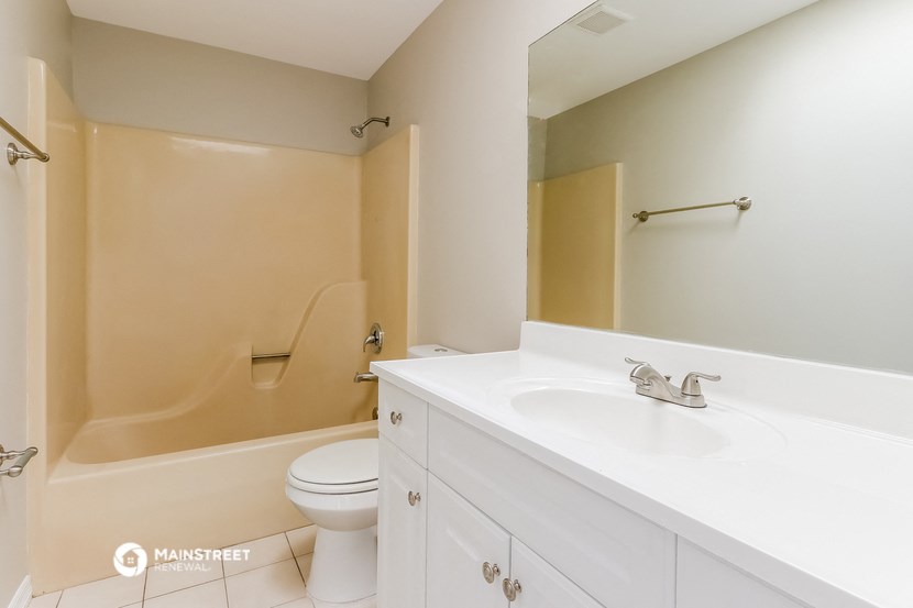 a bathroom with a sink and a toilet and a tub
