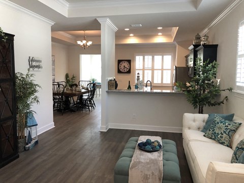 a living room and kitchen with a couch and a table