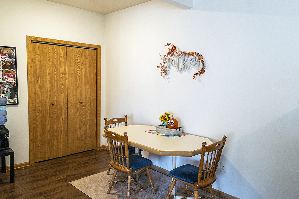 a dining room with a table and chairs and a door