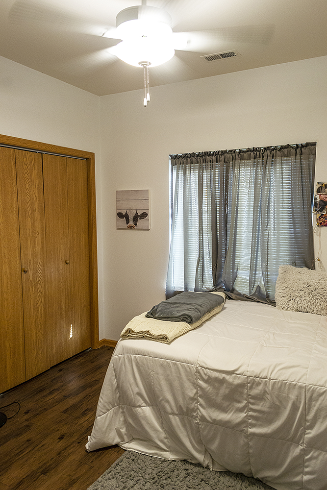 a bedroom with a bed and a window and a wardrobe