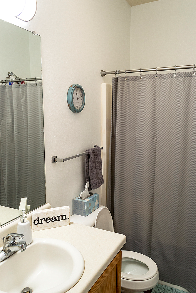 a bathroom with a shower and a sink and a toilet