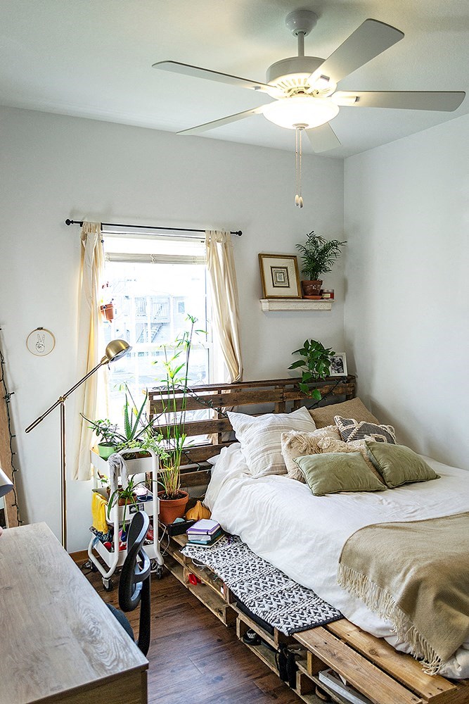 a bedroom with a bed and a ceiling fan