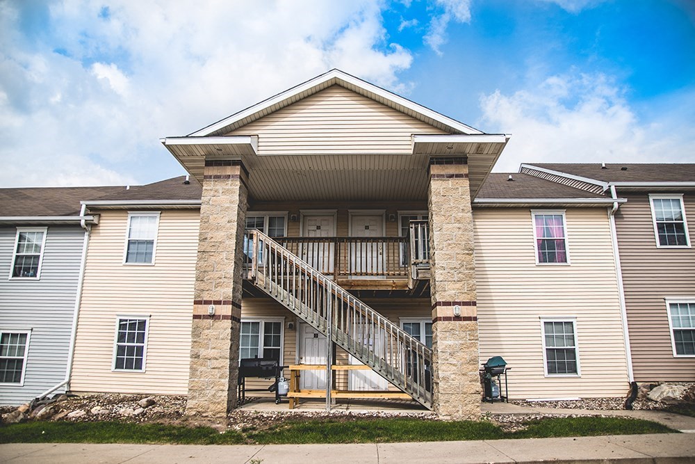 the front of a large house with a staircase