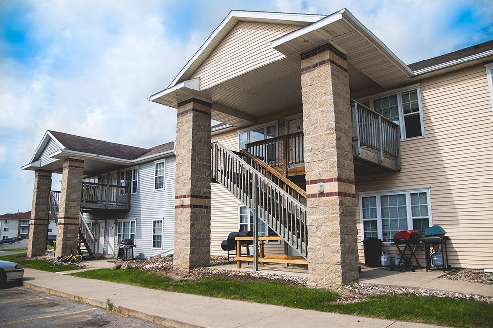the front of a house with a porch and a staircase