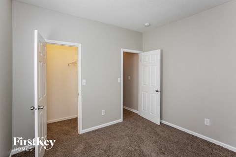 a bedroom with a closet and an open door
