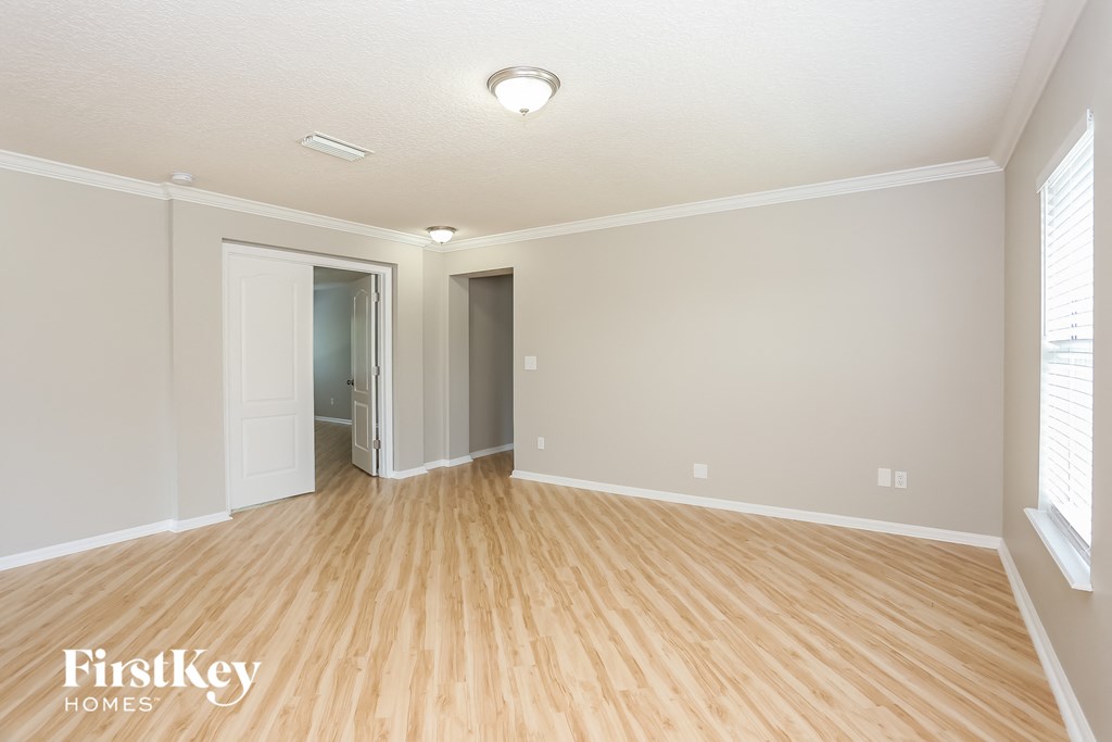 the living room and dining room with wood flooring