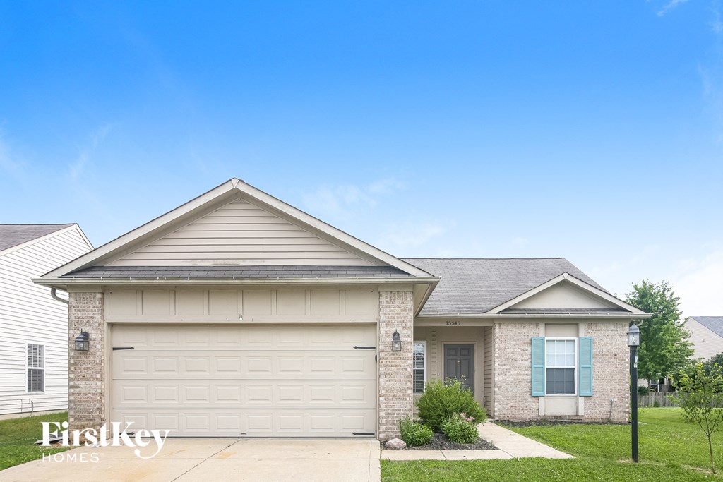 a brick house with a white garage door
