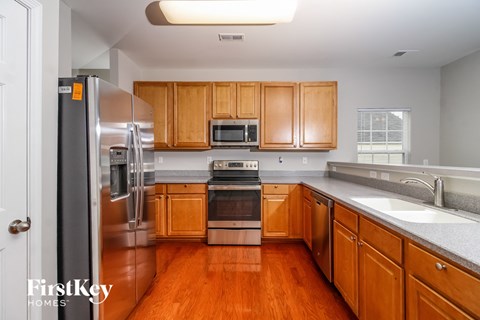 a kitchen with wooden cabinets and stainless steel appliances