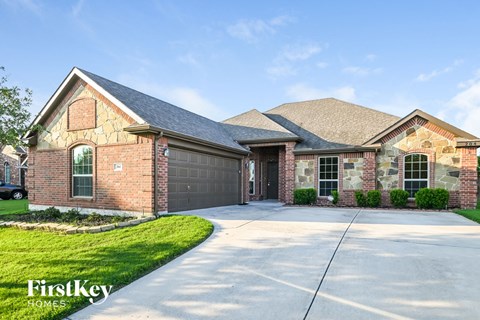 A brick house with a garage door and a driveway.