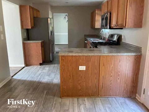 A kitchen with wooden cabinets and a countertop.