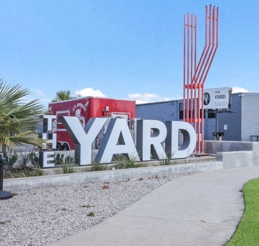 a large sign for the yard in front of a building