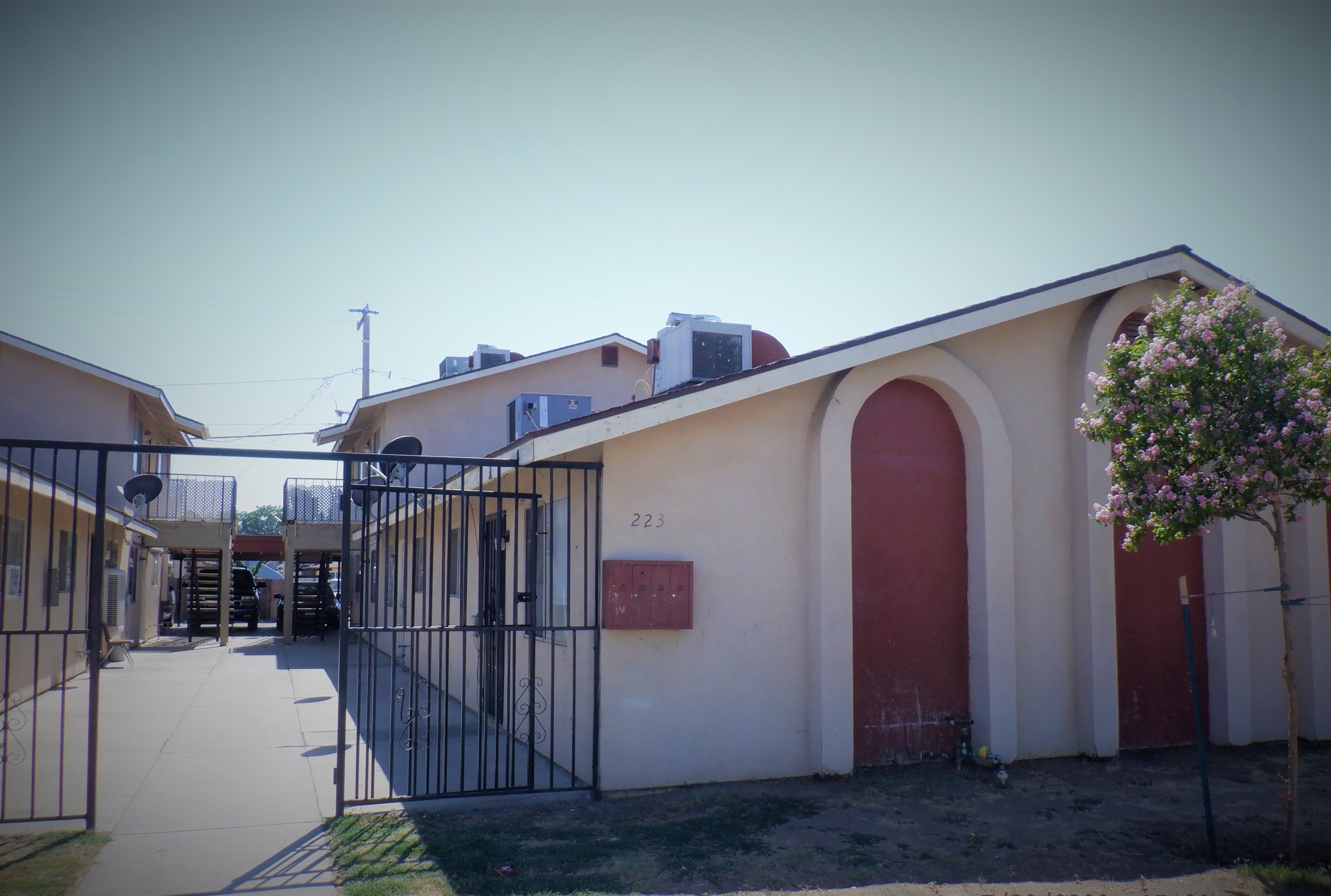 a building with a red door and a metal gate