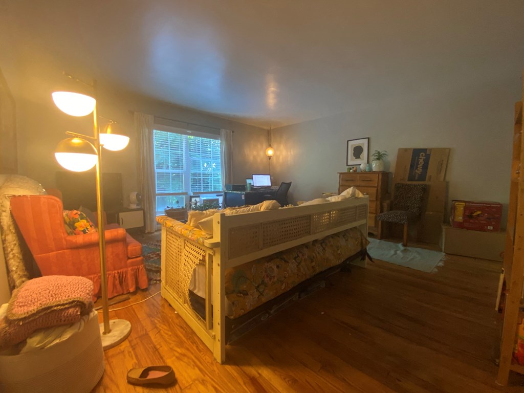 a bedroom with a crib and a living room with a couch