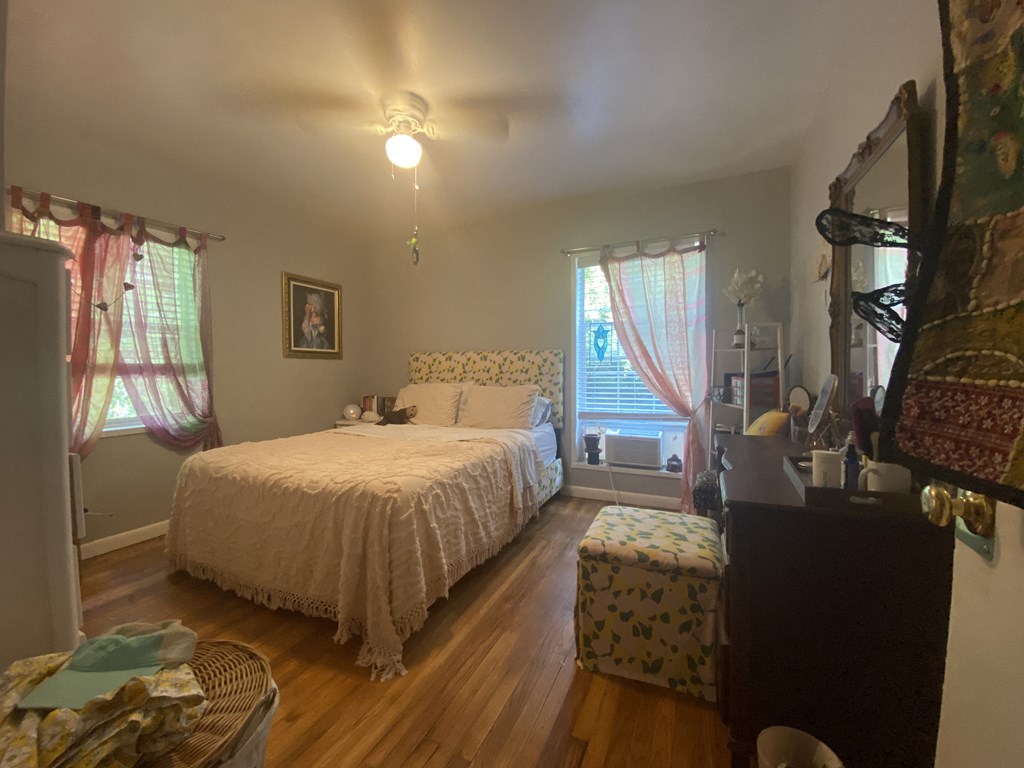 a bedroom with a bed and a dresser and a window