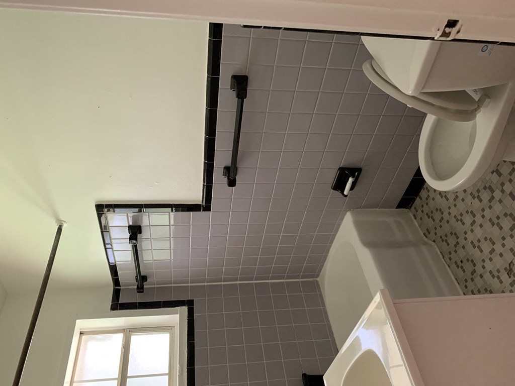 a bathroom with a urinal and a sink and a toilet