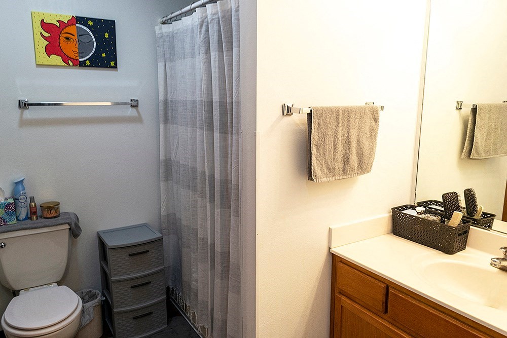 a bathroom with a toilet and a sink and a shower