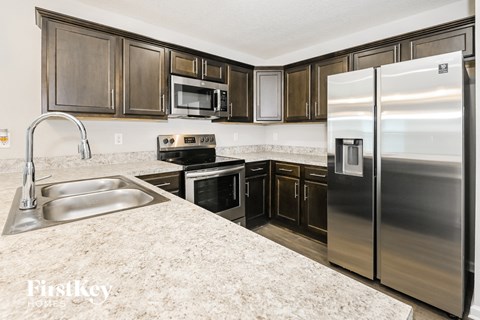 a kitchen with stainless steel appliances and granite counter tops