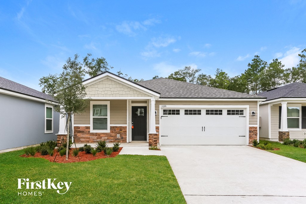 a house with a white garage door and a lawn
