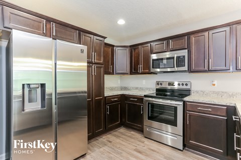 a kitchen with stainless steel appliances and wooden cabinets