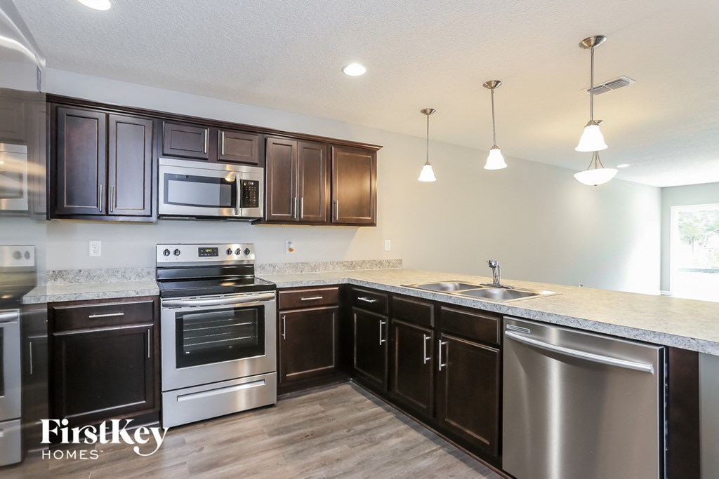 a kitchen with stainless steel appliances and marble counter tops