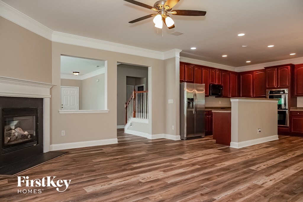 a renovated living room with a fireplace and a kitchen