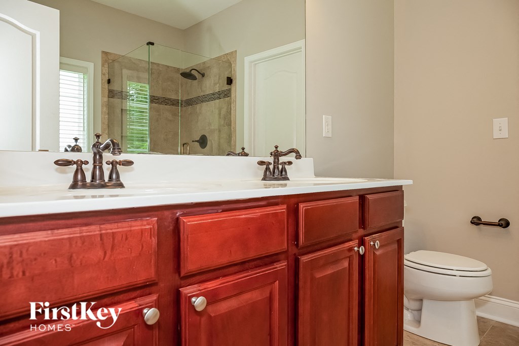 a bathroom with a sink and a toilet and a mirror