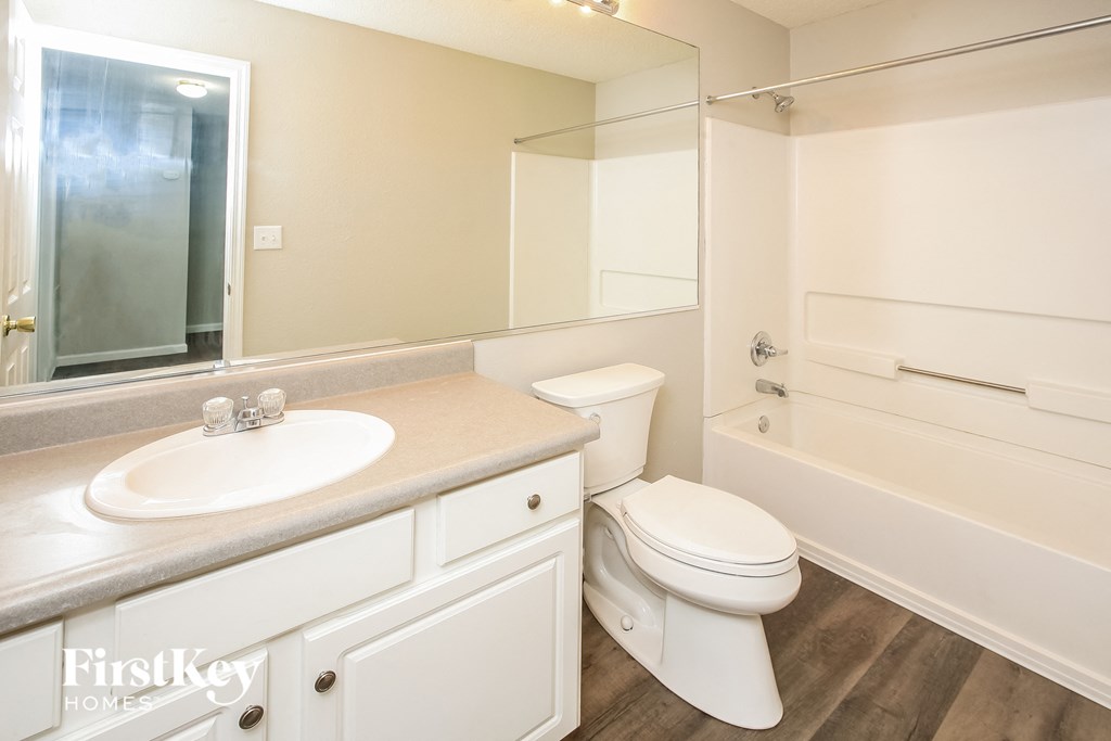 a bathroom with a sink toilet and a bath tub