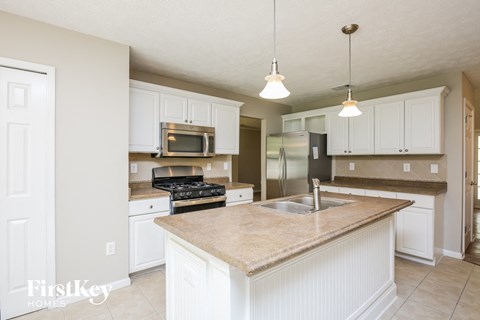 a kitchen with white cabinets and a counter top