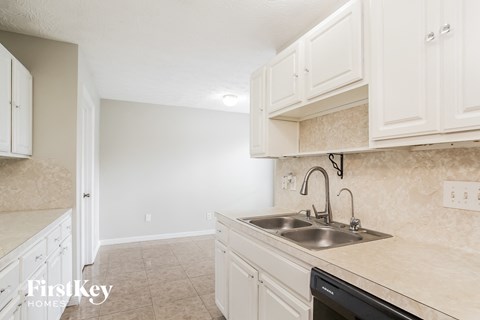 A kitchen with a sink and cabinets.