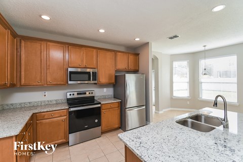 A kitchen with wooden cabinets and stainless steel appliances.