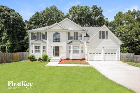 a white house with white siding and a lawn