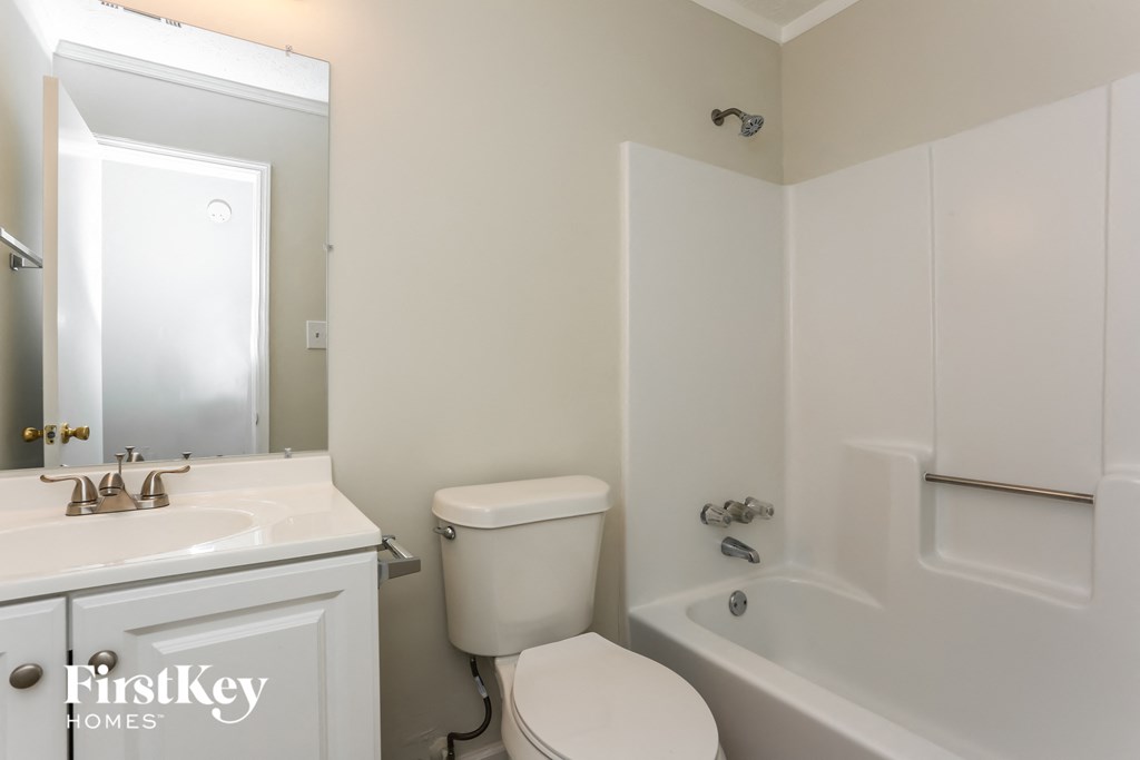 a white bathroom with a sink toilet and bath tub