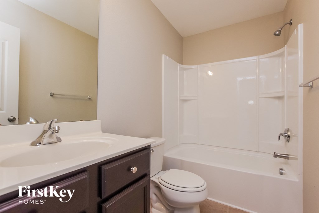a bathroom with a sink toilet and a shower
