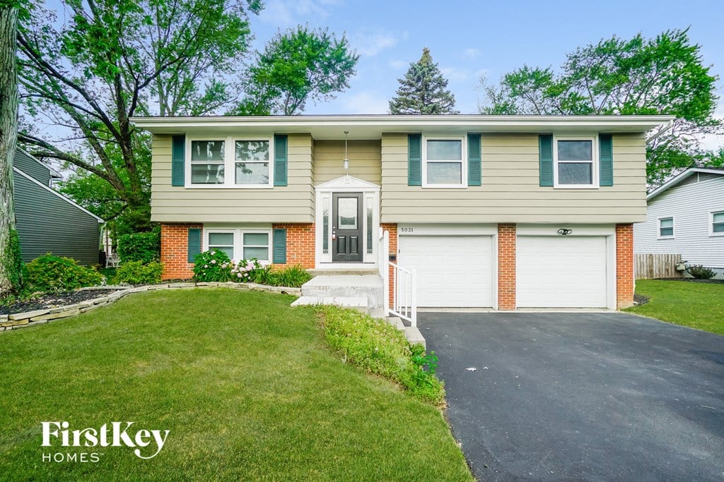 A two-story house with a garage is for sale.