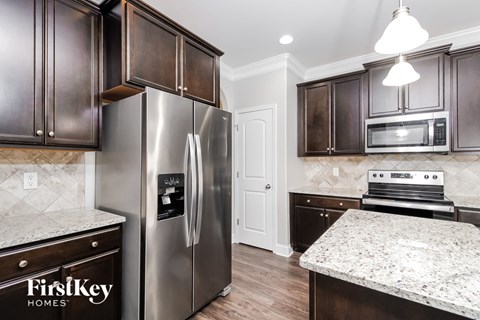 a kitchen with stainless steel appliances and marble counter tops