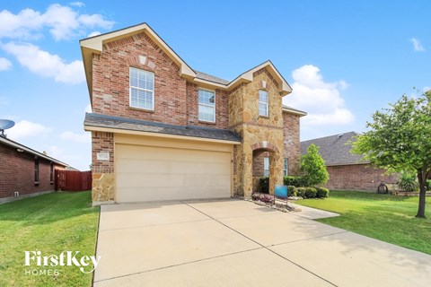 a large brick house with a garage and a driveway