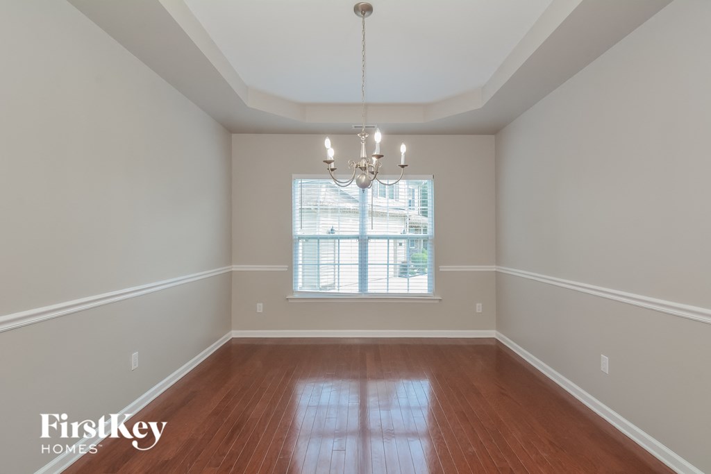 A room with wooden floors and a chandelier.
