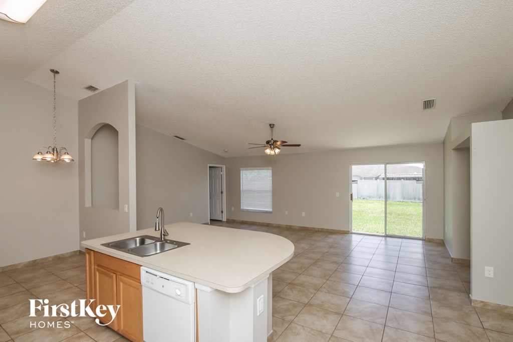 the kitchen and living room are spacious and open to the backyard