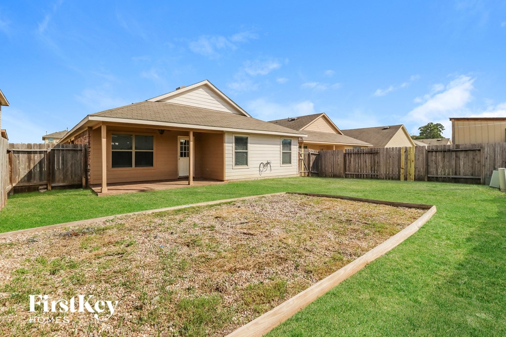 a backyard with a lawn and a house