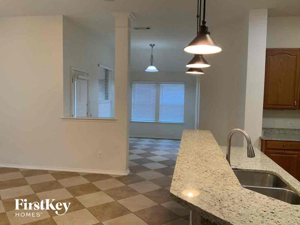 an empty kitchen with a sink and a counter top