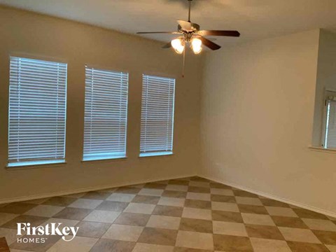 a living room with a checkered floor and a ceiling fan